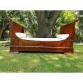 A French Flame Mahogany Lit-En-Bateau / Daybed on Wooden Castors. Circa 1950