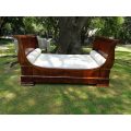 A French Flame Mahogany Lit-En-Bateau / Daybed on Wooden Castors. Circa 1950