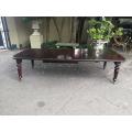 A three meter Victorian mahogany extending dining table on carved legs and castors, with four lea...