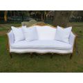 A French Louis XVl Style Gilded Settee Upholstered in a White Linen with Three Scatter Cushions