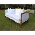 A French Louis XVl Style Gilded Settee Upholstered in a White Linen with Three Scatter Cushions