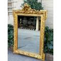 A Heavily Carved and Gilded Mirror ND