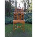 A 20th Century Carved Mahogany and Teak Wood Architectural Cathedral Style Birdcage on Stand