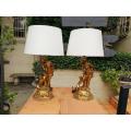 A Pair of Gilded Composite Cherub Table Lamps