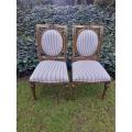 A Pair of French Style Hand-Gilded Chairs