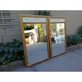 A 20th Century Pair OF French Style Gilt and Painted Mirrors