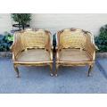 A 20th Century Pair or French Bergere Style Carved and Hand Gilded in Gold Leaf Wooden Chairs