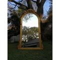 A French Style Ornately Carved Arched and Gilded Bevelled Mirror