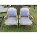 A Pair of French Style Giltwood Ornate Arm Chairs on Fluted legs
