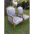 A Pair of French Style Giltwood Ornate Arm Chairs on Fluted legs