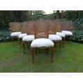 A 20th Century French Set Of Ten Walnut And Rattan Dining Chairs Consisting Of Two Carvers And Ei...