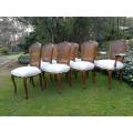 A 20th Century French Set Of Ten Walnut And Rattan Dining Chairs Consisting Of Two Carvers And Ei...