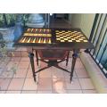 A Victorian Circa 1850s Amboyna and Ebonised Games Table with Rosewood, Walnut and Beechwood Ch...