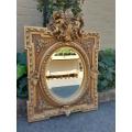 An Exceptional Pair of 20th Century French Style Ornately Carved and Gilded Bevelled Mirrors with...