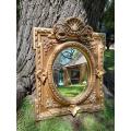 A 20th Century French Style Ornately Carved and Gilded Bevelled Mirror