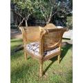 A 20TH Century French Style Carved Ornate Rattan Arm Chair