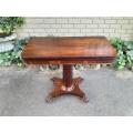 A Victorian rosewood swivel and tilt CARD TABLE, on spreading hexagonal column to the concave pla...