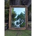 A 20th Century French Style Ornately Carved And Hand Gilded Bevelled Mirror