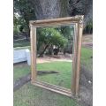 A 20th Century French Style Ornately Carved And Hand Gilded Bevelled Mirror