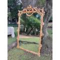 A French Rococo Style Ornately Carved and Gilded Bevelled Mirror 1