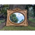 A French Rococo Style Ornately Carved and Gilded Bevelled Mirror 4