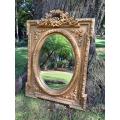 A French Rococo Style Ornately Carved and Gilded Bevelled Mirror 5