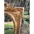 A French Rococo Style Ornately Carved and Gilded Bevelled Mirror 5