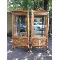 A Pair of French Louis XVI Style Ornately Carved & Gilded Showcases