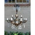 A 20th Century French Style Antique Brass and Crystal Twelve Light Chandelier
