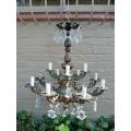 A 20th Century French Style Antique Brass and Crystal Twelve Light Chandelier