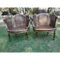 A French Louis XVI Style Pair of Ornately Carved Giltwood Rattan Bergere Chairs