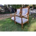 A Pair of French Style Ornately Carved Giltwood Arm Chairs