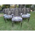 A French Louis XVI Style Set of Eight (8) Ornately Carved and Gilded Rattan Dining Chairs