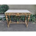 A 20th Century Ornately Carved and Hand-Gilded Console Table with Cream Marble Top
