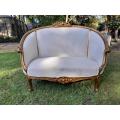 A French Style Ornately Carved and Gilded Bergere Chair