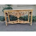 A 20th Century Ornately Carved and Hand-Gilded Console Table with Cream Marble Top