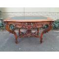 A 19TH Century Ornately Carved and Gilt Wood Rococo Style Table with Leather Insert