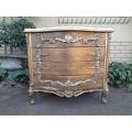 A French Style Ornate and Gilded Chest of Drawers with Marble Top