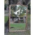 A French Style Ornately Carved and Gilded Bevelled Mirror of Large Proportions