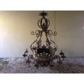 A Large Wrought Iron and Hand-Painted Imported Chandelier with Crown Detail