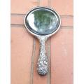 An Antique Repouss Sterling Silver Hand Held Mirror with signed initials "HDD"