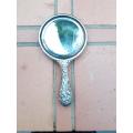 An Antique Repouss Sterling Silver Hand Held Mirror with signed initials "HDD"