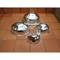 A late 19th century set of four graduated silver-plate food domes ND