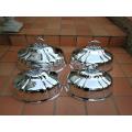 A Set Of Four Silver-Plate Food Domes