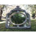 A French Ornate carved painted mirror with a bevelled centre section