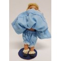 Vintage Hard Plastic Doll 26cm dressed in hand stitched dress on metal stand as per photo