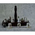 14 THIMBLES ON A WOODEN HOLDER - from SUEZYT