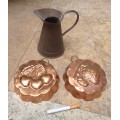 2 vintage copper cooking molds and a copper jug