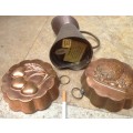 2 vintage copper cooking molds and a copper jug