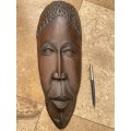 African wood face carving dark wood  , as if a  mask wall mount